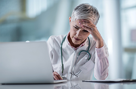 image-doctor stressed at computer